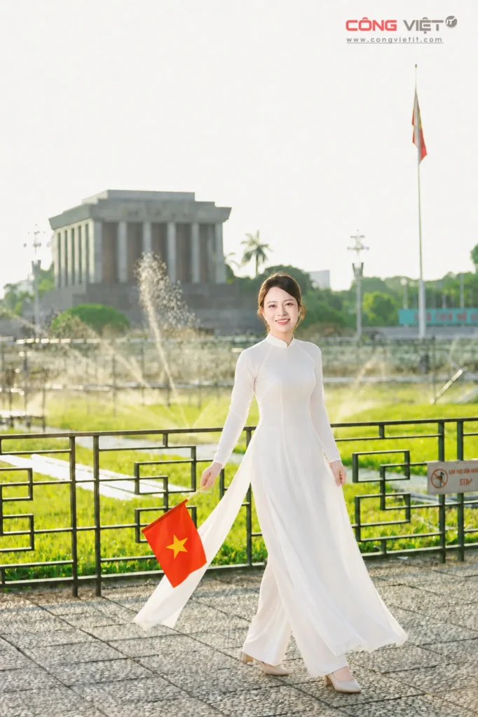 Người phụ nữ bước đi trong tà áo dài trắng cầm cờ Việt Nam dịp Quốc khánh